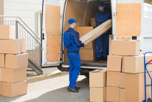 Man with van removal service operating in a Walthamstow residential street